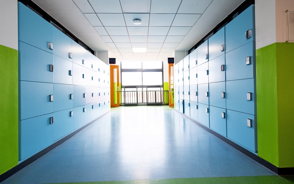Empty school hallway with lockers, representing the hidden dangers of non-physical sexual abuse in schools, such as grooming and manipulation.