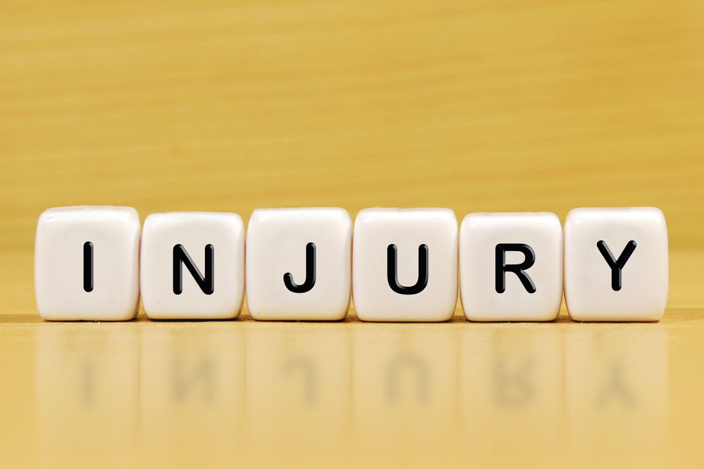 The word “injury” spelled out in white blocks, representing the rise in Uber accident injuries and growing concerns over rideshare safety.