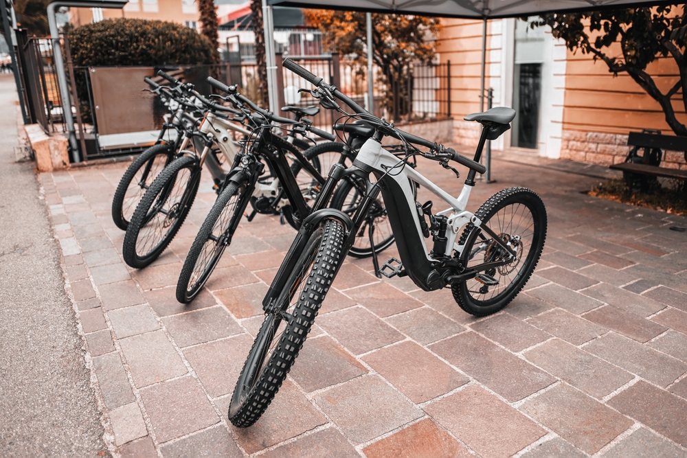 Modern e-bikes lined up outdoors, reflecting both their convenience and the dangers highlighted by recent e-bike crashes.