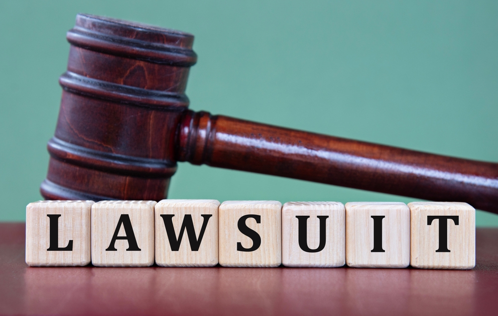 A judge’s gavel and blocks spelling 'LAWSUIT,' representing the legal action taken by the FTC and 21 states against Uber for deceptive billing practices.