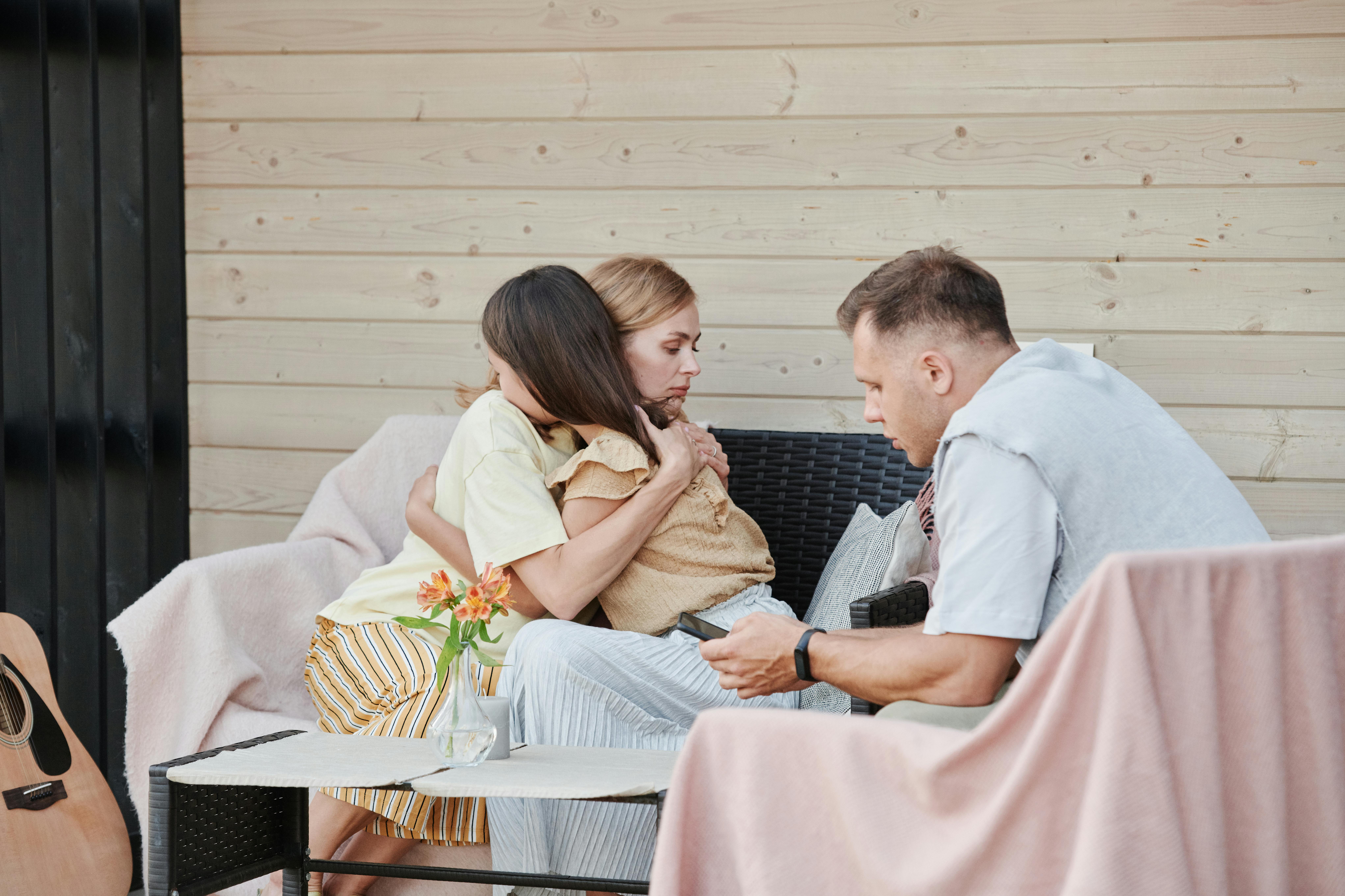 Parents comforting a young child while discussing concerns about school sexual abuse in New Jersey