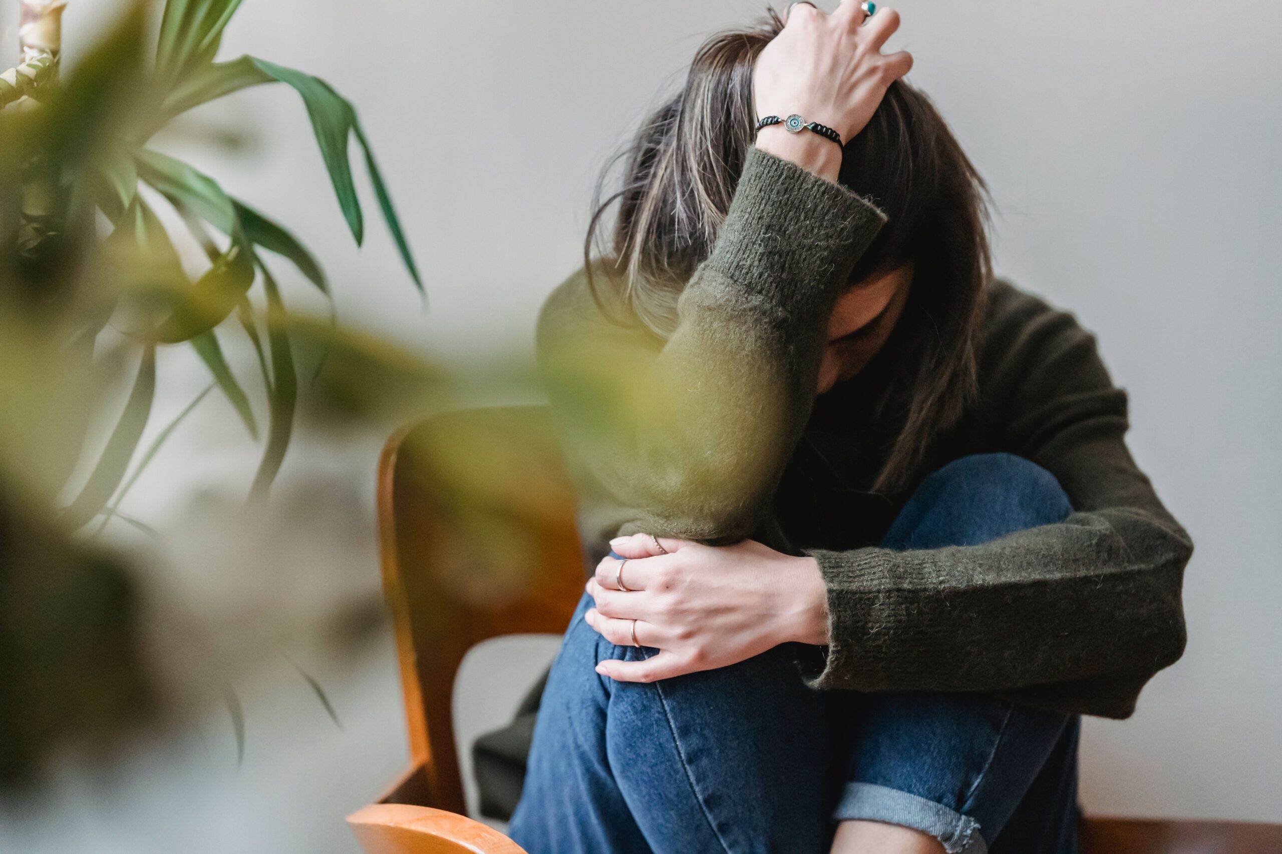 Woman sitting with head down showing anxiety and emotional distress after a car accident