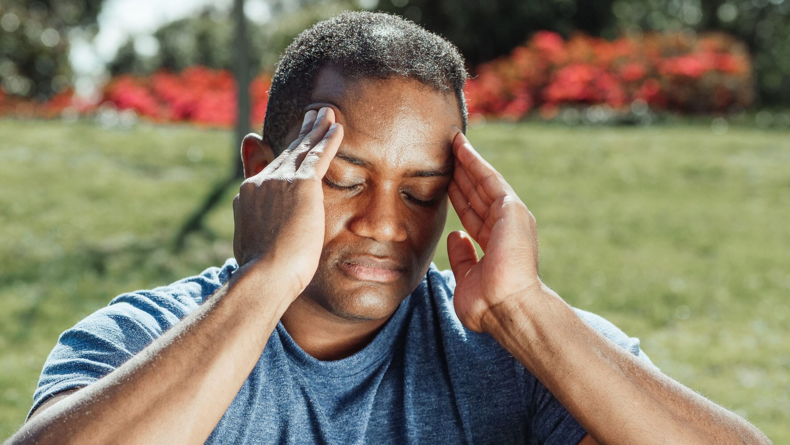 Man holding his head in pain from a head injury after a car accident in New Jersey