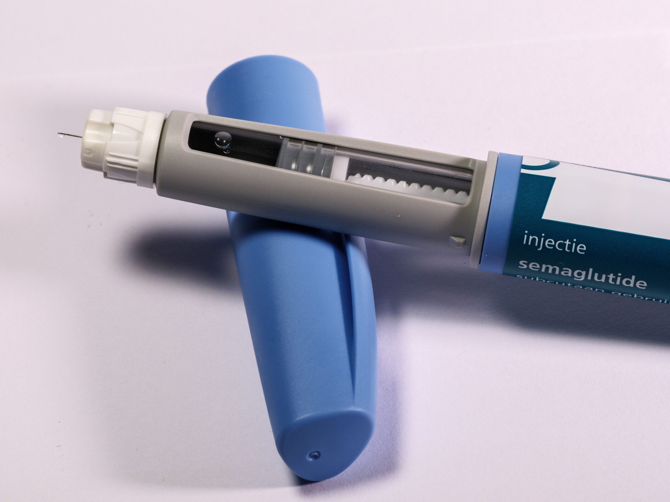 Close-up of a semaglutide GLP-1 injection pen showing the medication window and needle.